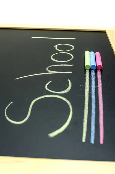 Color chalks on blackboard — Stock Photo, Image