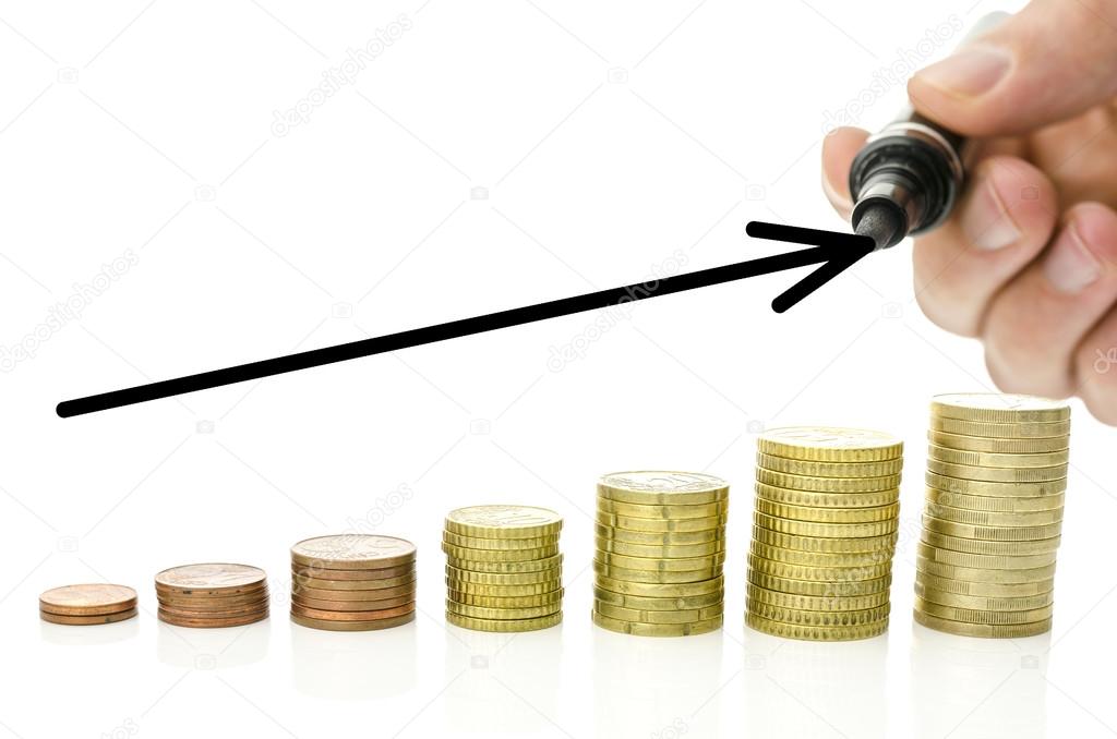 Growing stacks of Euro coins with black rising arrow over them. With copy space.