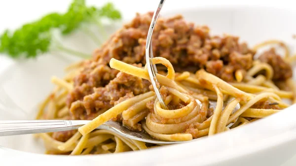 Rolling spaghetti bolognese on a fork — Stock Photo, Image