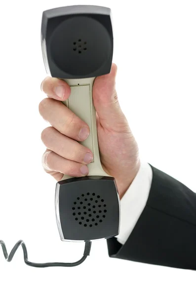 Hand of a businessman holding telephone receiver — Stock Photo, Image