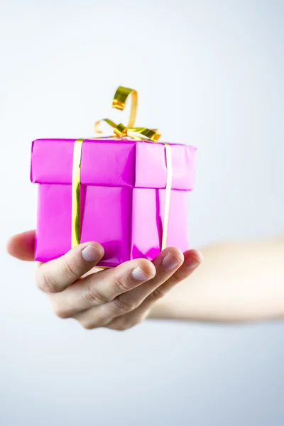 Holding pink wrapped present — Stock Photo, Image