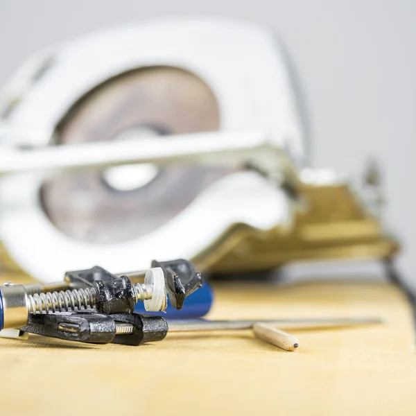 Carpentry clamp and circular saw — Stock Photo, Image