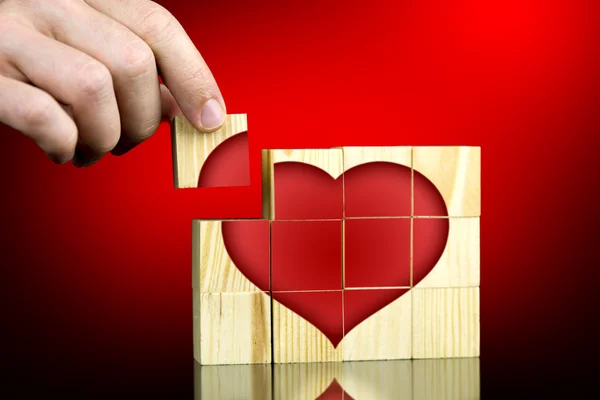 Man completing a red romantic heart shape — Stock Photo, Image