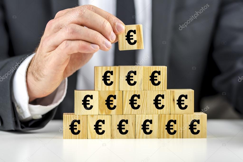 Man building a pyramid of euro symbols
