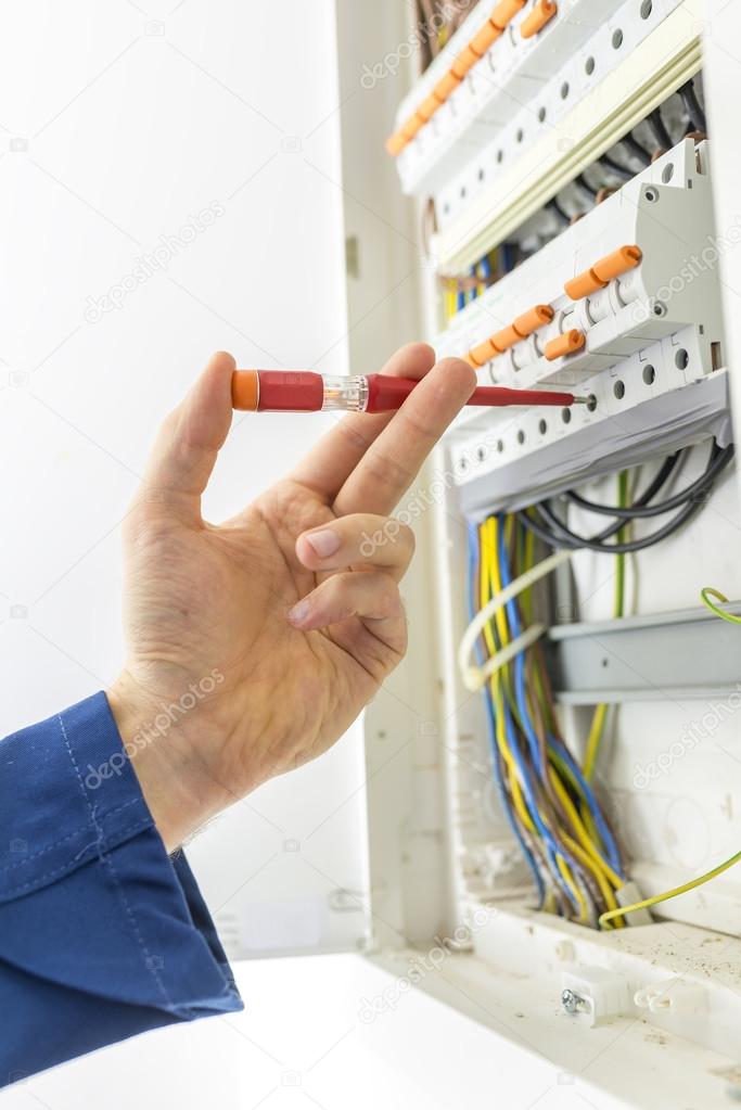 Electrician checking the electrical supply box