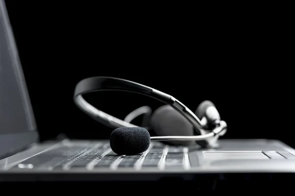 Headset lying on a laptop computer — Stock Photo, Image