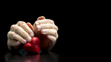 Man cupping his hands protectively over a heart