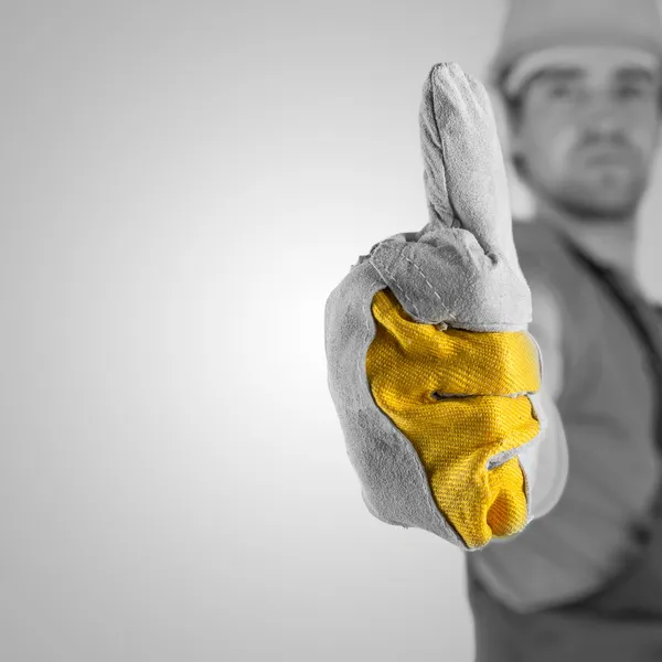 放弃一个大拇指的建筑工人 免版税图库照片
