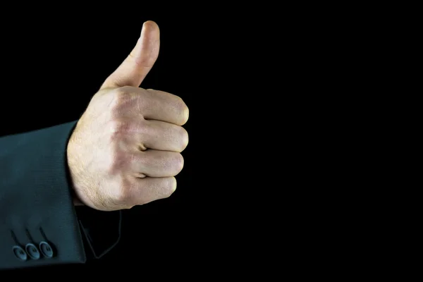 Hand of a man showing thumb up, on black — Stock Photo, Image