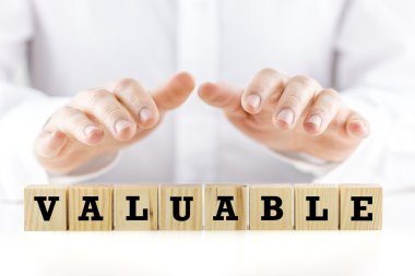 The word - Valuable- on wooden cubes clipart