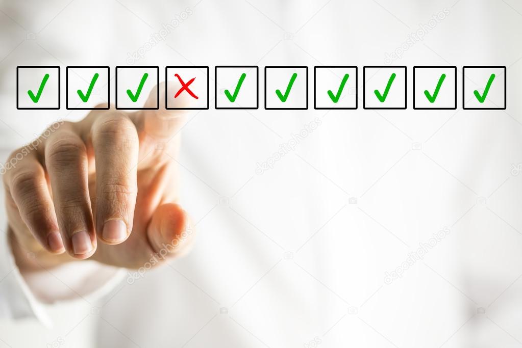 Man selecting a cross from a line of check marks