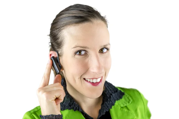 Woman touching the hands free placed at her ear — Stock Photo, Image