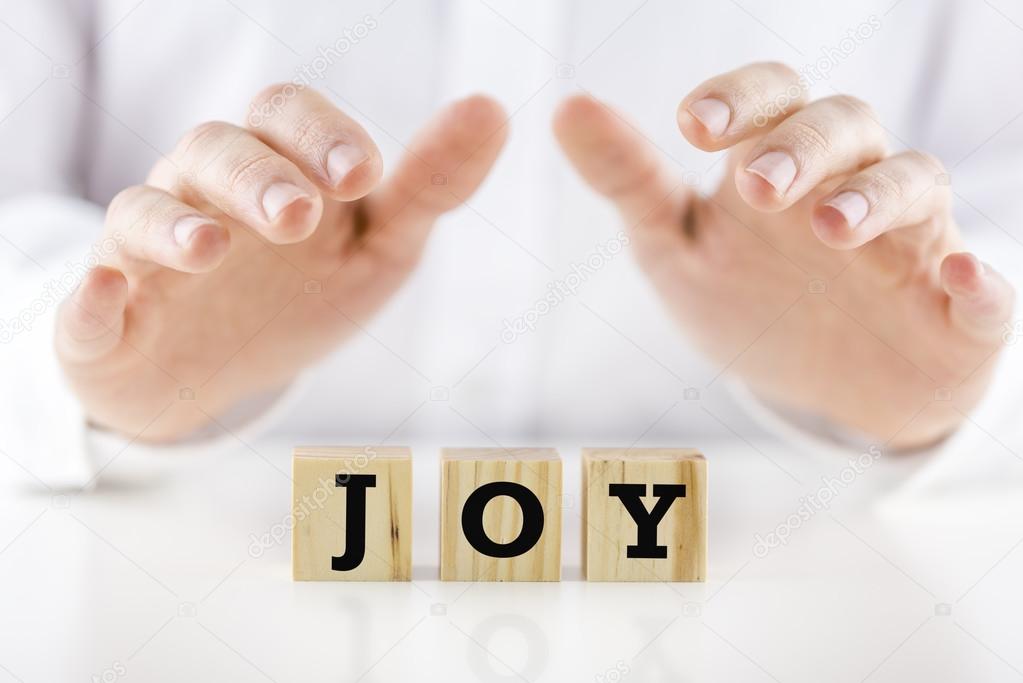 Mans hands cupped over the word Joy