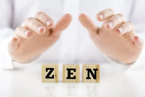 Man holding protective hands above the word Zen — Stock Photo, Image