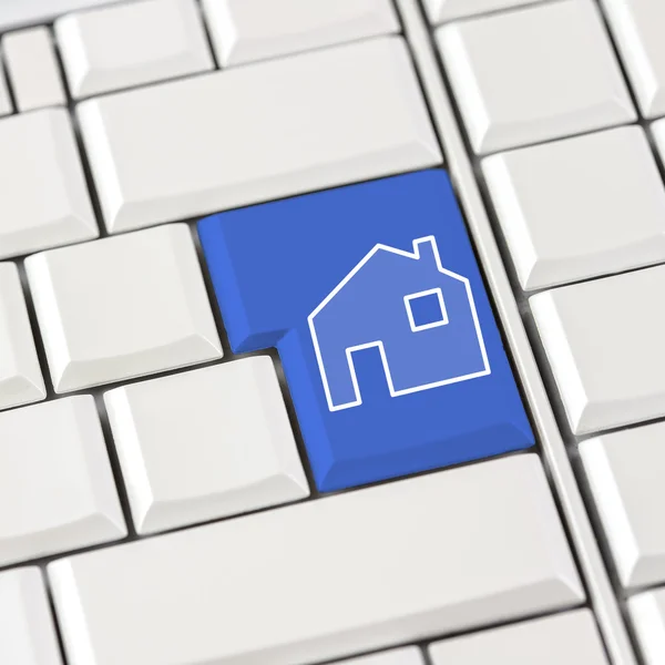 Blue house icon on a computer keyboard — Stock Photo, Image