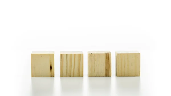 Four wooden cubes or building blocks — Stock Photo, Image