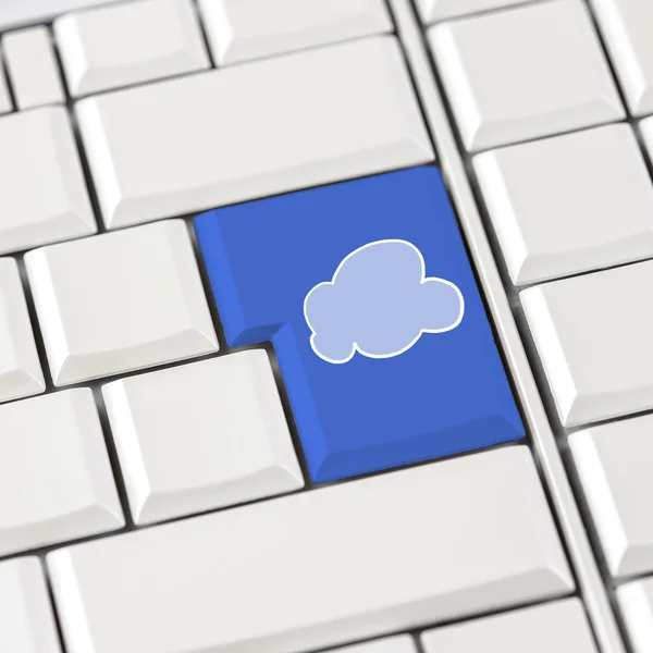 Cloud icon in blue on a white computer keyboard — Stock Photo, Image