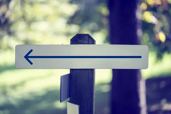 Rustic wooded signboard with a left arrow — Stock Photo, Image