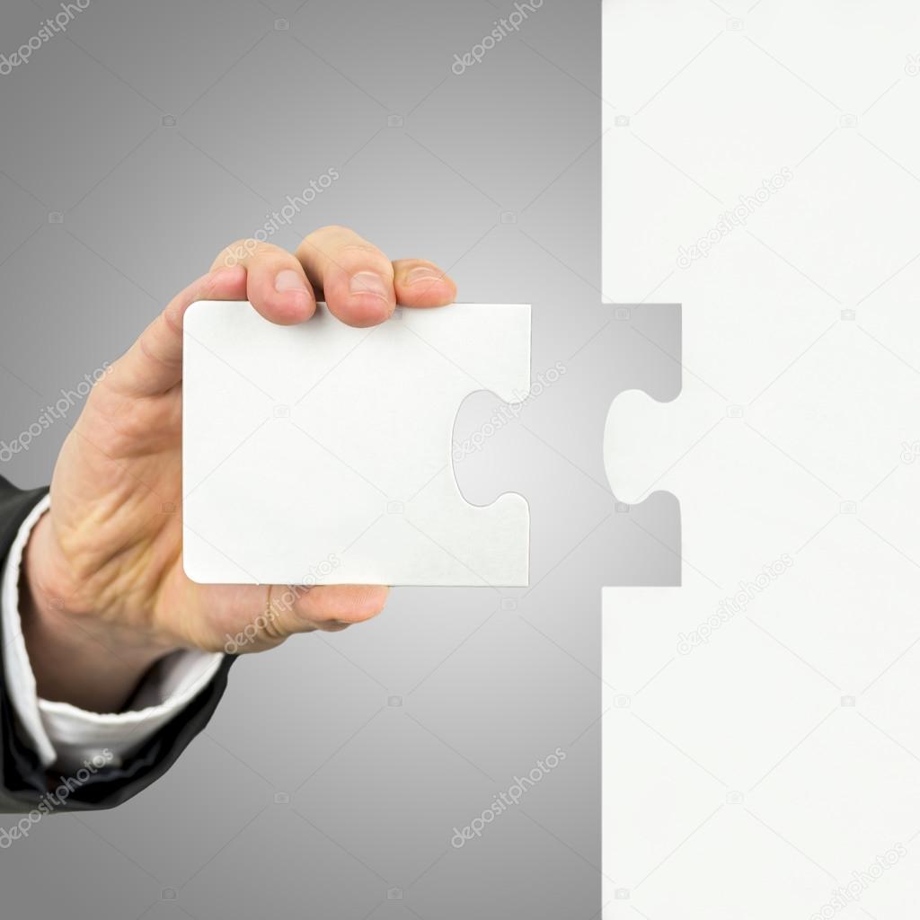 Businessman holding the missing piece of a puzzle
