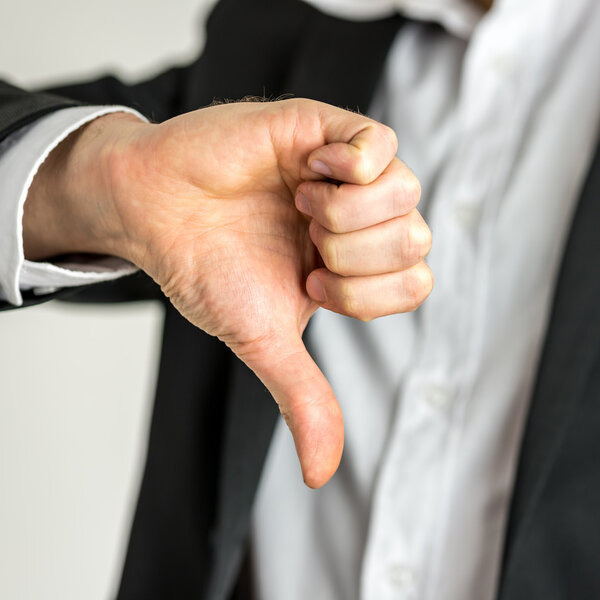 Man giving a thumbs down gesture of disapproval