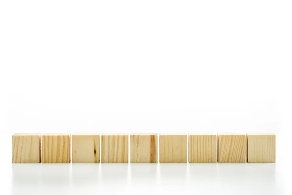 Row of nine blank wooden blocks — Stock Photo, Image