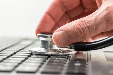 Man checking the health of his laptop computer clipart