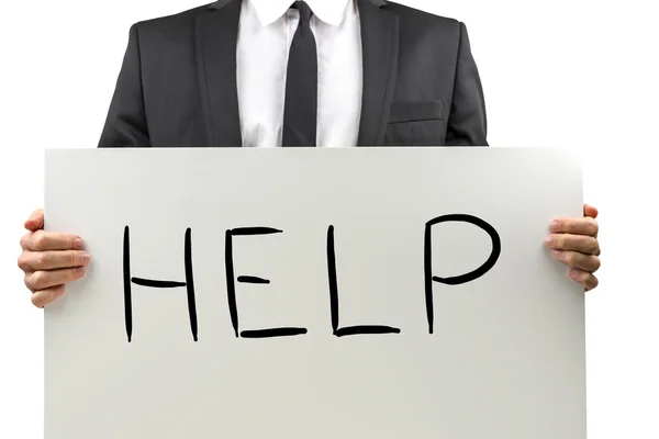 Businessman holding a sign with the word Help — Stock Photo, Image