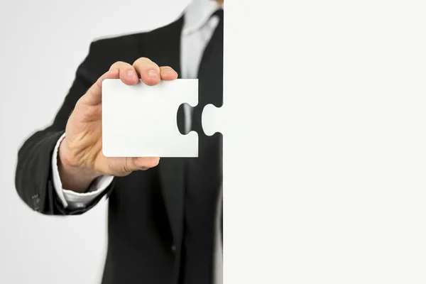 Businessman with a piece of the puzzle — Stock Photo, Image