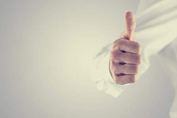 Retro style image of a man giving a thumbs up — Stock Photo, Image