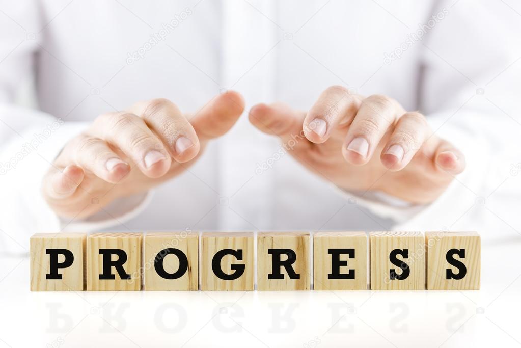 The word - Progress - on wooden cubes