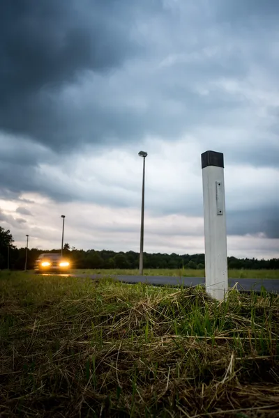 Illuminated pole on roadside — Stock Photo, Image