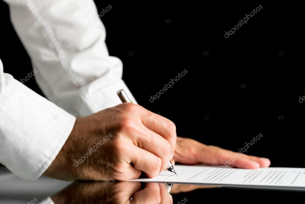 Man signing with a pen an official document