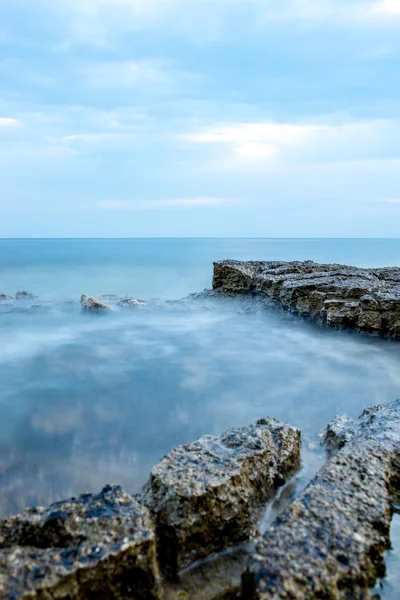 Nautical background with a rocky seashore — Stock Photo, Image