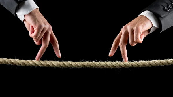 Two male hands making the walking sign on a rope — Stock Photo, Image