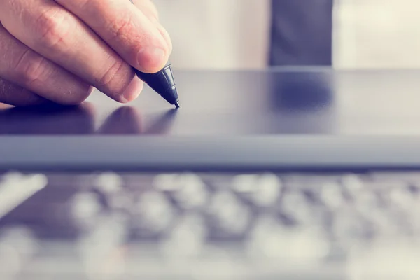 Tekenen met de stylus op een grijze grafisch tablet — Stockfoto