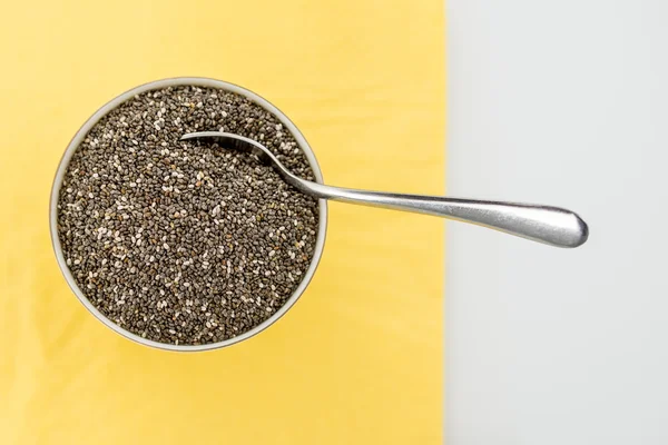 Bowl of dried chia seeds with a spoon — Stock Photo, Image