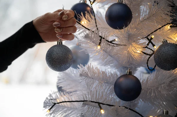 Closeup Female Hand Placing Shiny Blue Holiday Bauble White Christmas — Stock Photo, Image