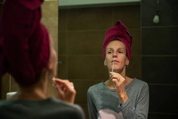 Young Woman Taking Nasal Swab Testing Stick Covid19 Self Home — стоковое фото