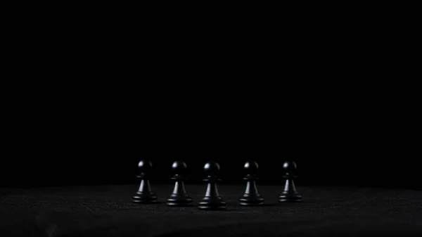 Five Black Pawn Chess Pieces Placed Row Black Background Conceptual — Stock Photo, Image