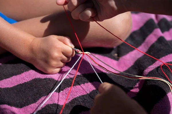 Closeup View Kids Knotting Multicolored Cotton Yarn Strings Make Bracelet — Fotografia de Stock