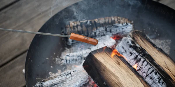 Grilling Hot Dog Sausage Stick Open Fire Cast Iron Fireplace — Stock Photo, Image