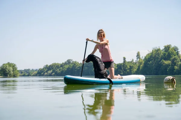 Female Dog Owner Her Black Labrador Retriever Sitting Sup Board — Stock Fotó