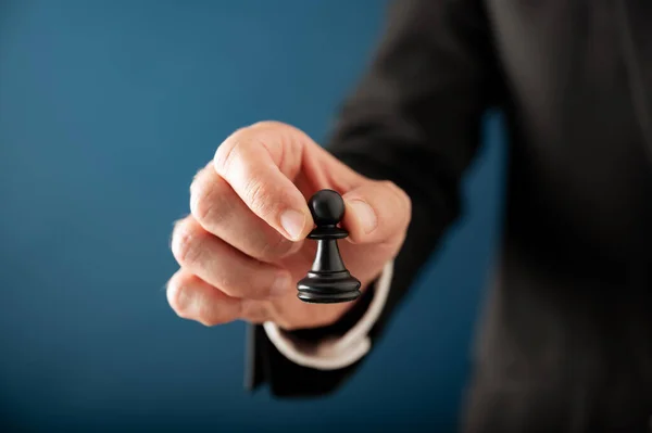 Closeup View Hand Businessman Holding Black Chess Pawn Piece Blue — Zdjęcie stockowe