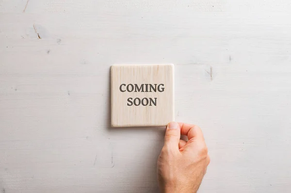 Male Hand Placing Wooden Tile Coming Soon Sign Plain Simple — Stock Photo, Image