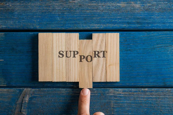 Male Finger Assembling Support Sign Spelled Wooden Pegs Placed Rustic — Stock Photo, Image