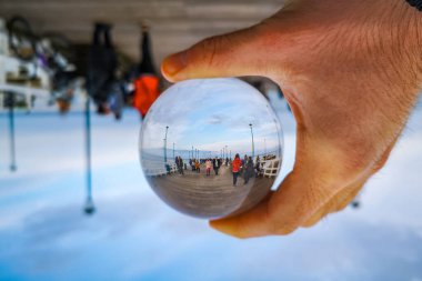 Gdansk, Polonya - 24 Ekim 2020: Brzezno 'daki iskele bulutlu sabahta kristal cam lensball' a yansıdı