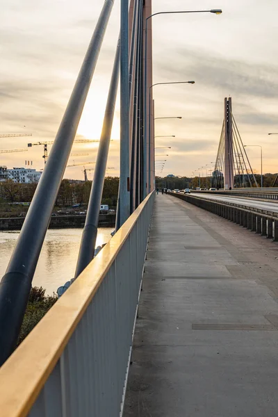 Wroclaw, Polonya - 15 Kasım 2020: Milenijny Köprüsü 'ndeki kaldırımdan görülen güzel bulutlu gün batımı 