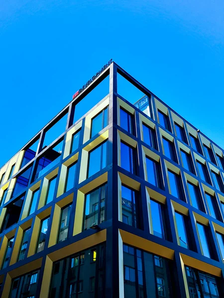 stock image Wroclaw, Poland - July 5 2021: Looking up to high modern building with gold and black framings around big windows