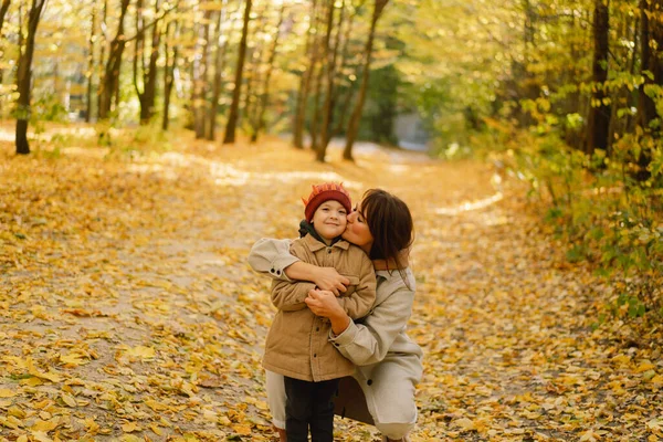 Madre e hijo están caminando en el bosque de otoño. Otoño actividad al aire libre para la familia con niños — Foto de Stock