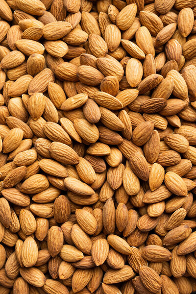 Background of organic almonds. Natural pure almond nuts. Healthy eating with food from nature